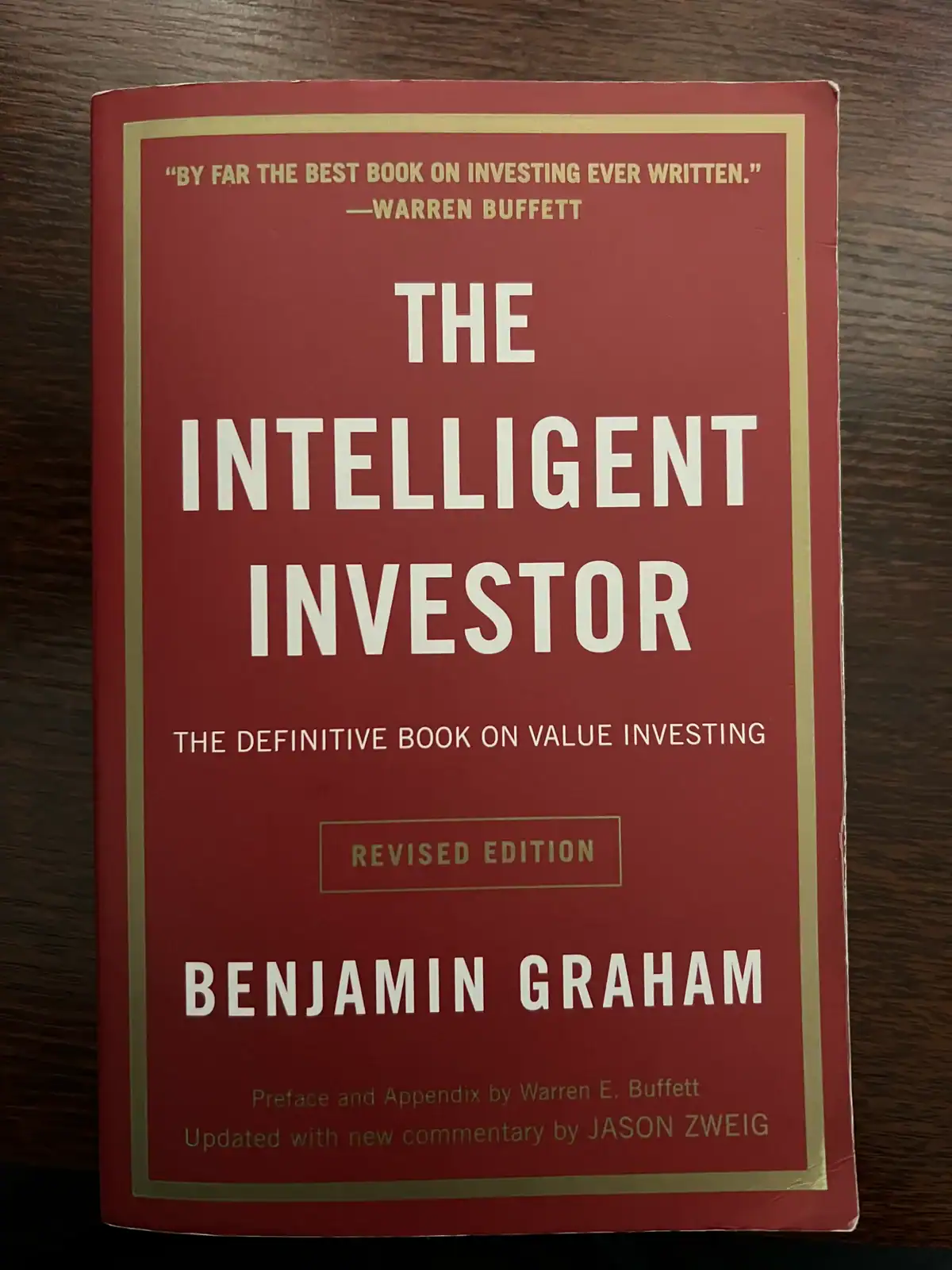 A book, The Intelligent Investor, on a table.
