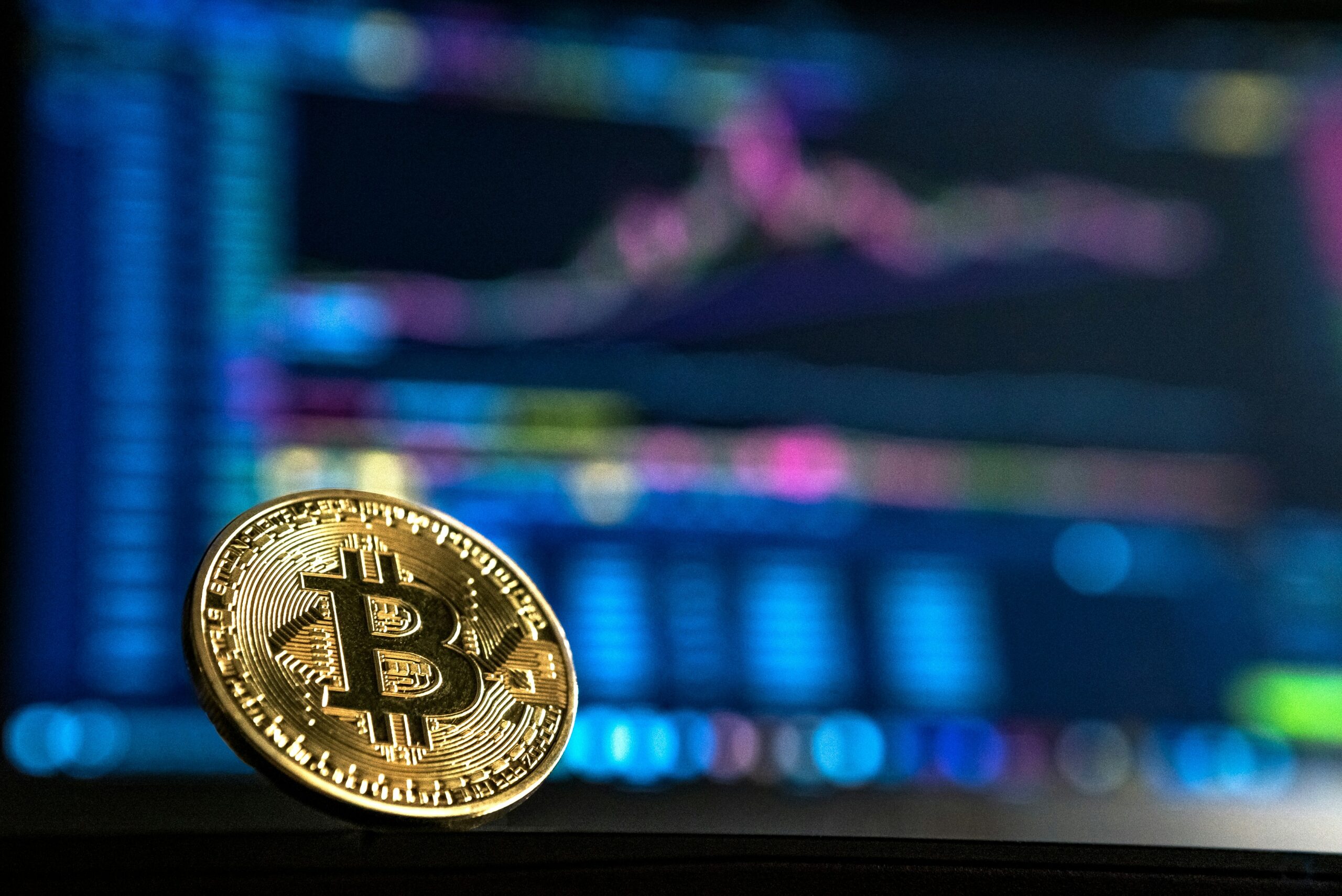 Bitcoin, with an investor's graph in the background.