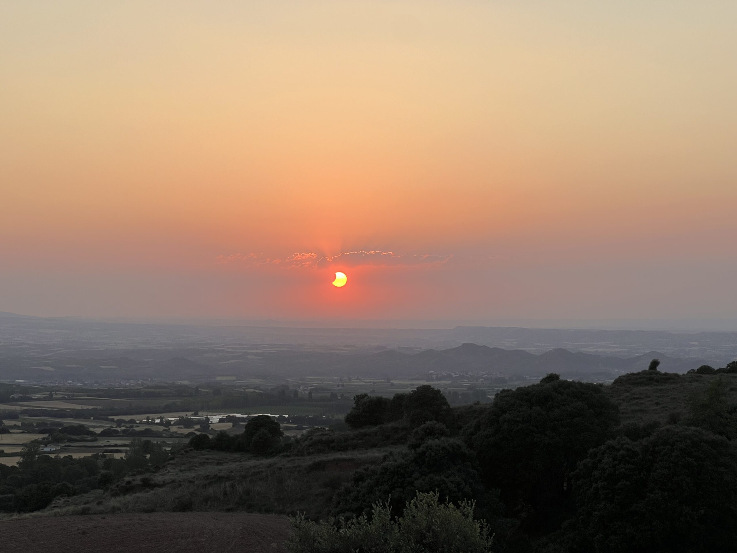 A partial solar eclipse at sunset.